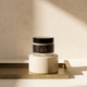 Muscle Butter USA recovery balm jar on a bone plaster pedestal and brushed brass tray